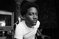 a black and white photo of a man sitting in a chair