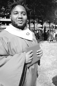 a black and white photo of a man holding a book