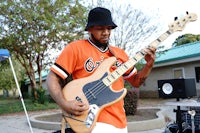 a man playing a bass guitar