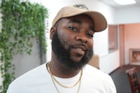 a man with a beard and a hat in an office