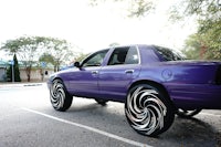 a purple suv parked in a parking lot