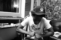 a black and white photo of a man sitting in a chair